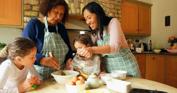 Siblings preparing food with family in kitchen 4k