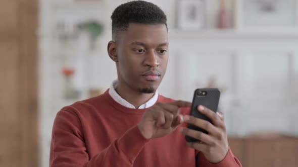 Portrait of African Businessman using Smartphone