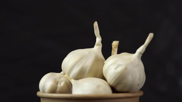 Heap of Garlic Spinning on Black Background Close Shot of an Heap of Garlic Solwly Rotating on a