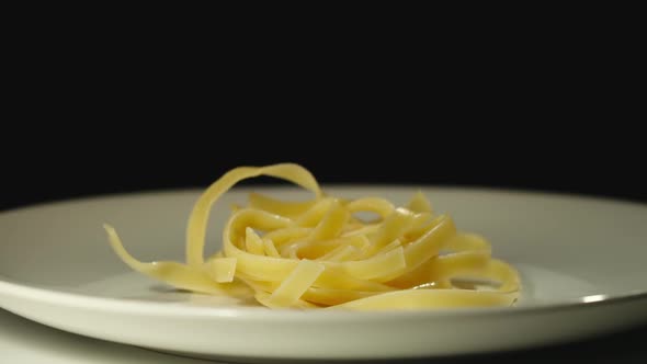 Cooked Pasta Nest Falls Into White Empty Plate