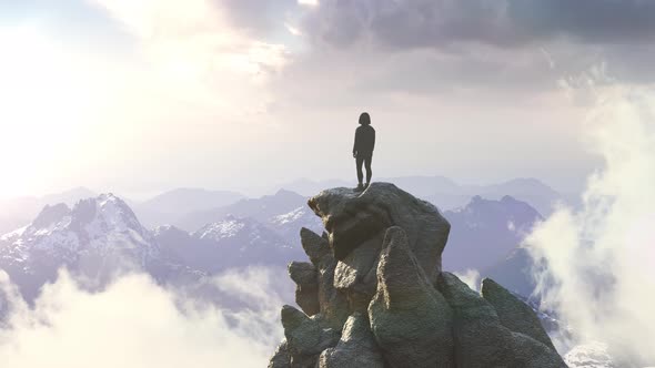 Adventurous Woman on a Rocky Mountain Overlooking Ocean Coast