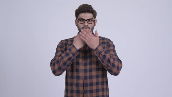 Young Bearded Indian Hipster Man Covering Mouth As Three Wise Monkeys Concept