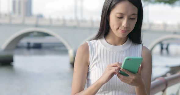 Woman Use of Mobile Phone at Outdoor