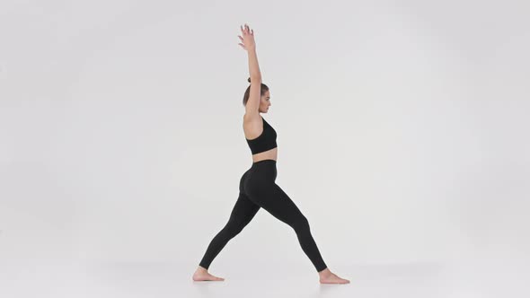 Full Length Portrait of Young Active Sporty Lady Practicing Warrior Position Doing Virabhadrasana