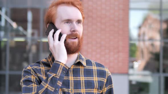 Outdoor Redhead Beard Young Man Talking on Phone