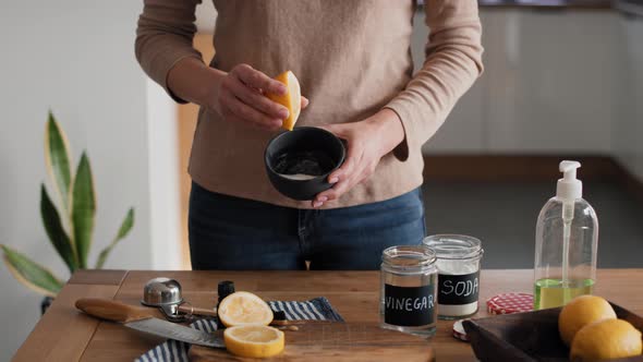 Unrecognizable person adding lemon juice to the bowl with DIY cleaning product. Shot with RED helium