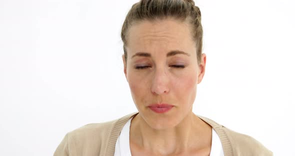Beautiful sick woman sneezing using a tissue