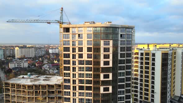 Aerial view of high residential apartment building under construction, Real estate development