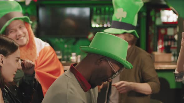 Friends Dancing In Pub On St Patricks Day