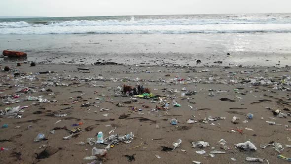 Sandy beach full with plastic garbage, polluted nature  in Bali, Indonesia