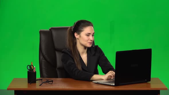 Business Woman Working on a Laptop Smiling Joyfully and Showing Ok Sign. Green Screen. Slow Motion