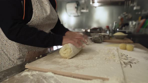 Close up female hands kneading the dough preparing fresh homemade pasta