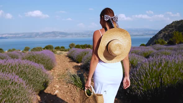 Woman Walking on Lavender Field