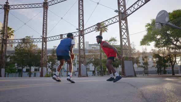 Cinematic footage of a street basketball game outdoor.