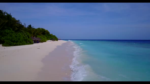 Aerial view seascape of idyllic coast beach adventure by blue ocean with white sandy background of a