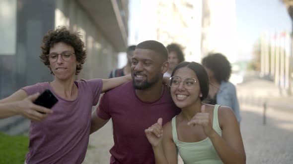 Laughing Friends Taking Selfie with Smartphone