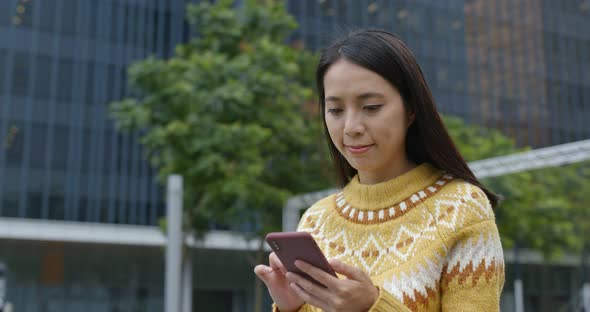 Woman work on mobile phone in city