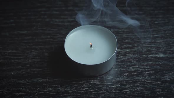 Tealight is extinguished and releases smoke, slow motion 120fps