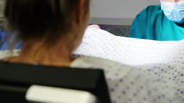 Doctor examining pregnant woman during delivery