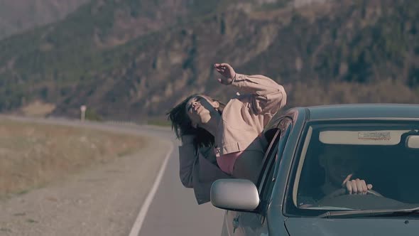 Lady Looks at Sky with Extended Arms Screams with Happiness