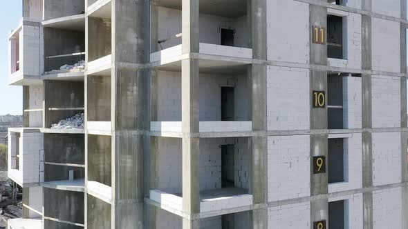 Aerial view of concrete frame of tall apartment building under construction in a city