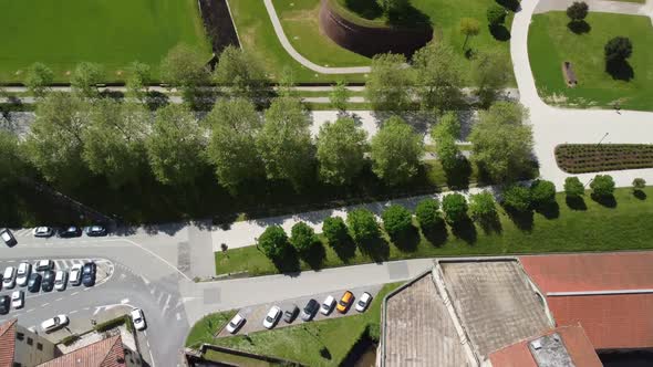 Aerial shot of garden and street full of parked car in the Lucca city. Province of Lucca, Tuscany, I