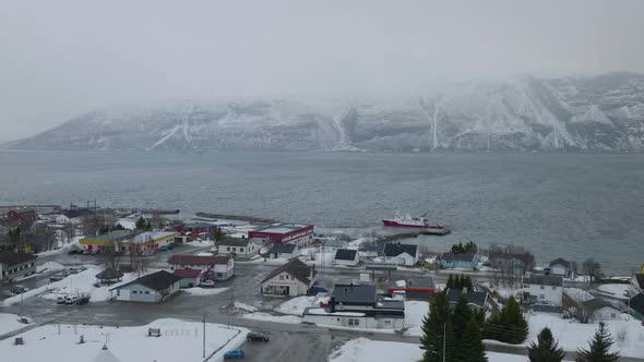 Kåfjord town centre and harbour in Olderdalen, Norway. Overcast winter weather.4k aerial drone shot