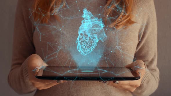 Hologram Screen On A Tablet With Digital Heart And Particles