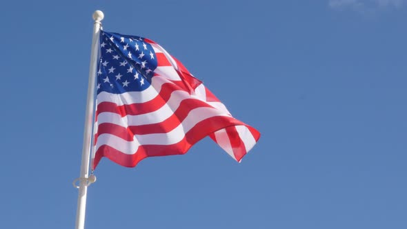 Recognizable United States of America flag in front of blue sky floating on wind 4K 2160p UltraHD fo