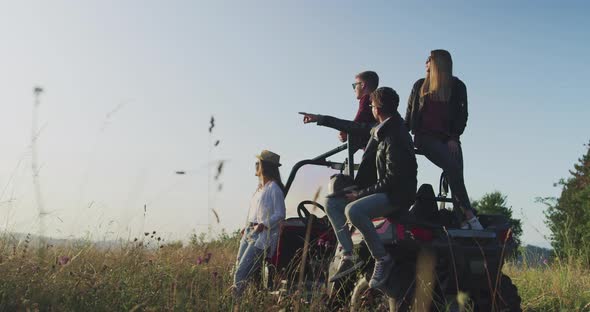 Group of Friends Enjoying Morning Sun on Off Road Car and Having Fun