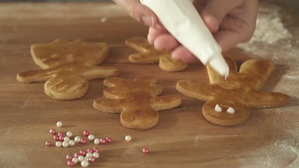 Decorating Ginger Bread Family for Christmas With Pastry Bag