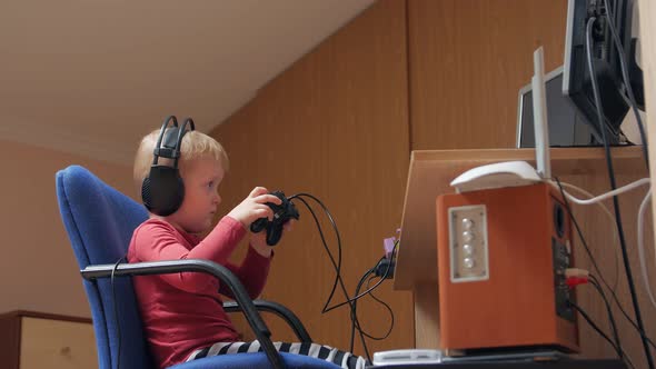 Little Boy Playing With Joystick alt