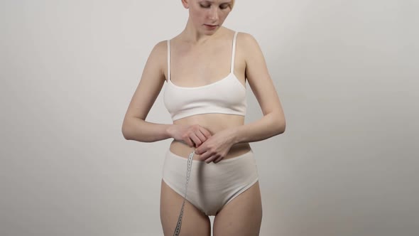 Young Slim Woman Is Measuring Waist