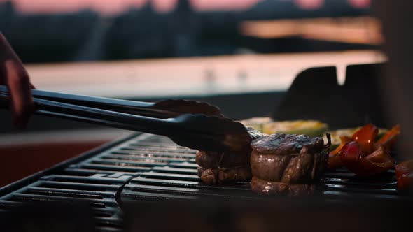 BBQ close-up: filet mignon steak and grilled vegetables cooking