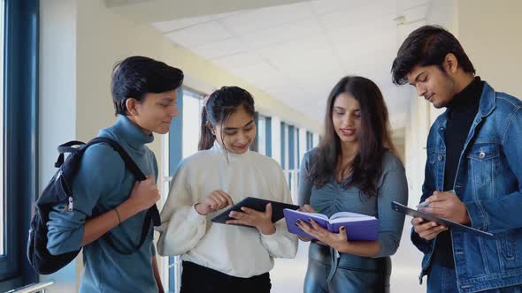 A Group of Indian Students with Books and a Tablet at the University