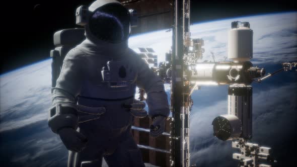 International Space Station and Astronaut in Outer Space Over the Planet Earth alt