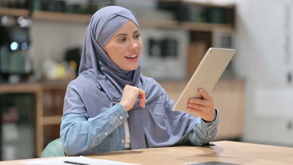 Online Video Chat on Tablet By Arab Woman at Work 