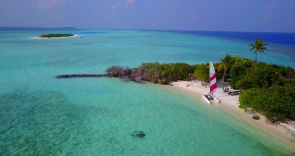 Tropical flying tourism shot of a summer white paradise sand beach and blue sea background in high r