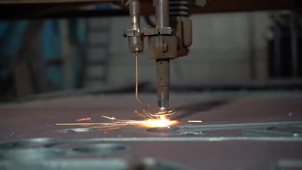 Laser plasma cutting of metal. Modern industrial technology. Industrial laser cutter with sparks.