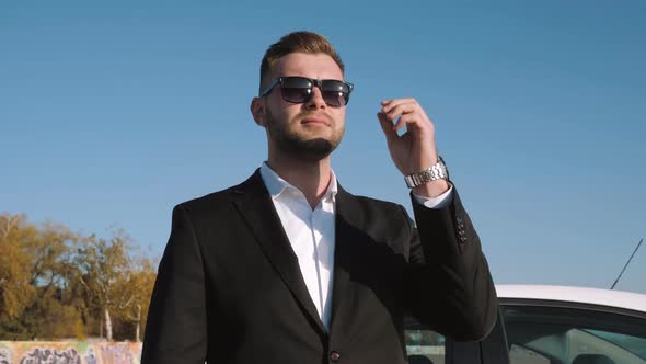 Businessman Takes Off Sunglasses. Slow Motion