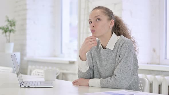 Thoughtful Young Latin Woman Thinking in Modern Office 