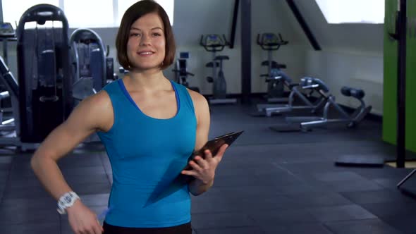 Sportswoman Holds Clipboard in Her Hand