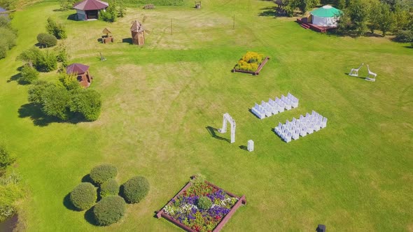 Green Site Prepared for Wedding Ceremony By Lake Upper View