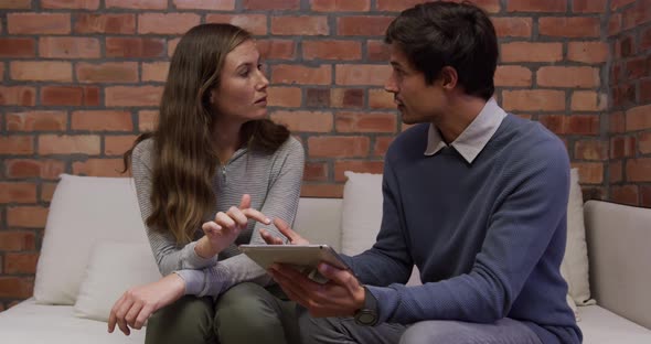 Creative businessman and bussinesswoman discussing over digital table in modern office