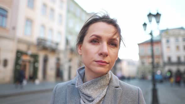 Portrait of a Caucasian Woman in a Coat in the Middle of the Old City Square / Videohive