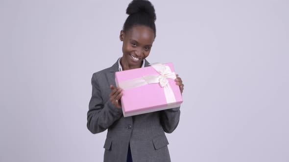 Young Happy African Businesswoman Holding Gift Box