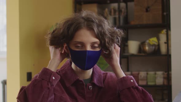 A Beautiful Lady is Putting a Protective Mask on Her Face