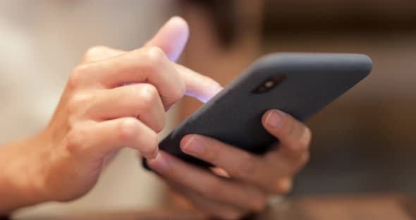 Woman use of mobile phone in restaurant