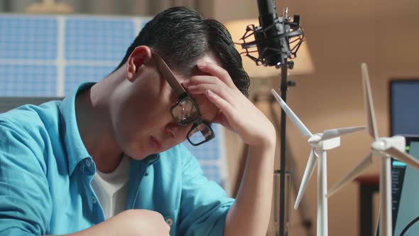 Close Up Of Asian Man Upset Failing Testing The Wind Turbine While Working Next To The Solar Cell