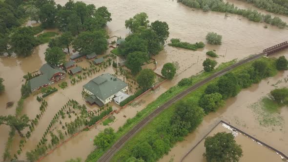 Aerial View of the Overflowing River. Flooded Buildings and Roads. Extremely High Water Level in the